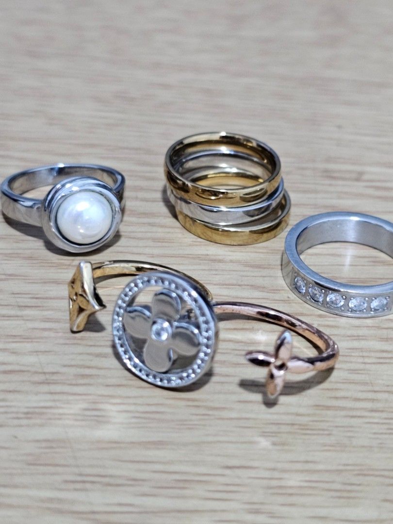 Assorted Fashion Rings Bundle Set Pearl Crystal Flower (Category: Rings) located in Caloocan City. Submitted by smart_shoppers_ville (Listing ID 1470148194, Image 2). Description: - Set of assorted fashion rings in various styles - Includes a crystal-embedded silver band and a classic pearl-accented ring - Features a trendy stackable mixed metal set - Comes with an open wrap ring adorned with cute clover charms - Versatile pieces great for mixing