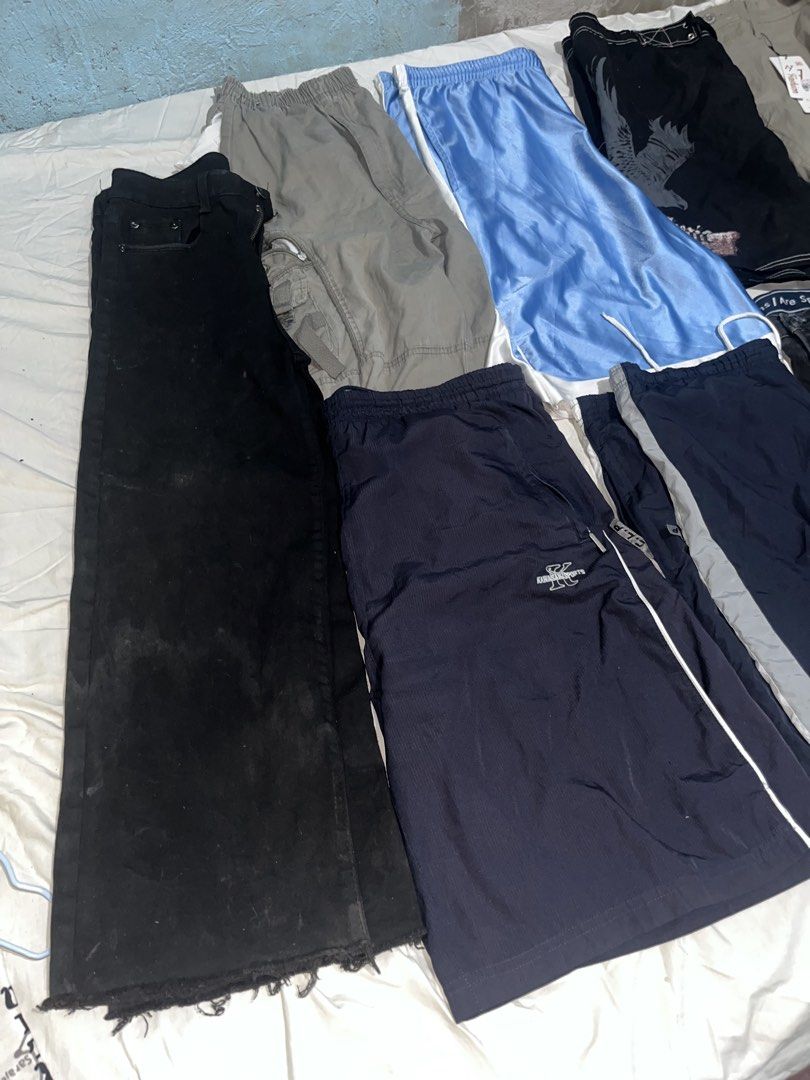 Assorted Pants and Shorts Bundle Multiple Styles Sizes (Category: Shorts) located in Manila. Submitted by unknownthrift. (Listing ID 1470346265, Image 1). Description: - All-in-one bundle of pants and shorts - Includes black jeans, blue basketball shorts, nylon track pants, and cargo pants - Colors: black, blue, navy, and grey - Versatile styles for casual or athletic wear - Great way to refresh your wardrobe rotation - Selling as a whole lot tog