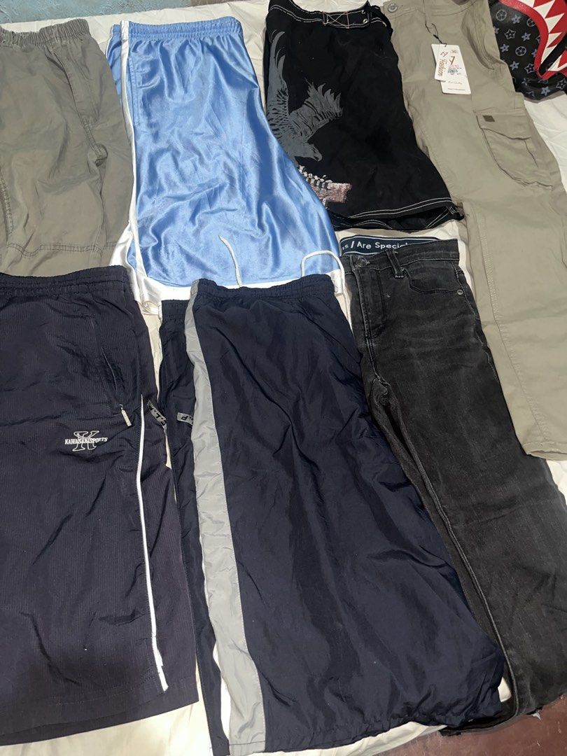 Assorted Pants and Shorts Bundle Multiple Styles Sizes (Category: Shorts) located in Manila. Submitted by unknownthrift. (Listing ID 1470346265, Image 3). Description: - All-in-one bundle of pants and shorts - Includes black jeans, blue basketball shorts, nylon track pants, and cargo pants - Colors: black, blue, navy, and grey - Versatile styles for casual or athletic wear - Great way to refresh your wardrobe rotation - Selling as a whole lot tog