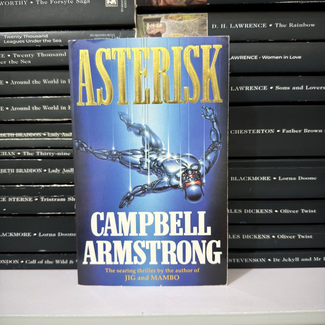 Asterisk by Campbell Armstrong Paperback Thriller Novel (Category: Storybooks) located in Lingayen. Submitted by readwjane (Listing ID 1470200367, Image 1). Description: - Title/Author: Thriller novel by Campbell Armstrong - Cover: Blue with metallic gold lettering and robotic figure illustration - Condition: Normal shelf wear on edges and corners - Genre: Searing suspense and thriller fiction (for fans of JIG and MAMBO) - Format: Paperback.