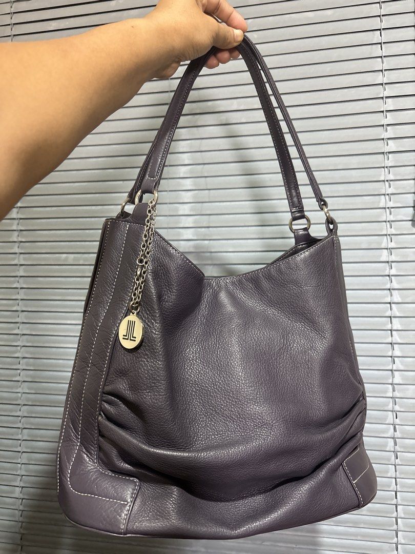 Auth Lanvin (Category: Shoulder Bags) located in Cordova. Submitted by cb_bagz_n_bloom (Listing ID 1470310831, Image 1). Description: Gorgeous dark purple leather shoulder bag with a slouchy shape and white contrast stitching. Features double straps, pebbled texture, and a chic Lanvin logo charm. Spacious interior for your daily essentials. Perfect for everyday use! PM for details..
