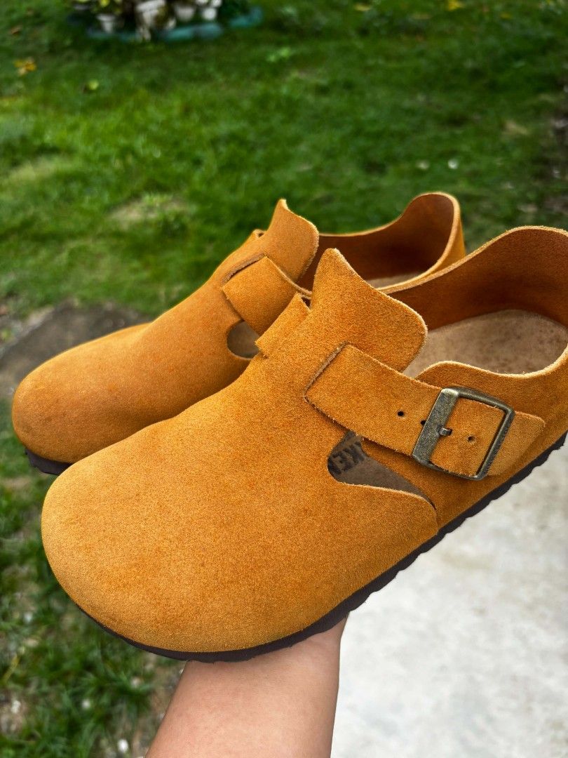 Authentic Birkenstock London Suede (Category: Flats & Sandals) located in Matalom. Submitted by eam_01 (Listing ID 1470161620, Image 2). Description: • Brand: Birkenstock • Model: London (Closed-Back Clog) • Size: EU 36 / US Women's 5-5.5 (230 mm) • Material: Premium Suede Leather Upper • Color: Mustard / Ochre / Warm Tan Condition Notes: • Uppers: Soft suede uppers are in good shape with typical light variations in texture from gentle wear. • Fo