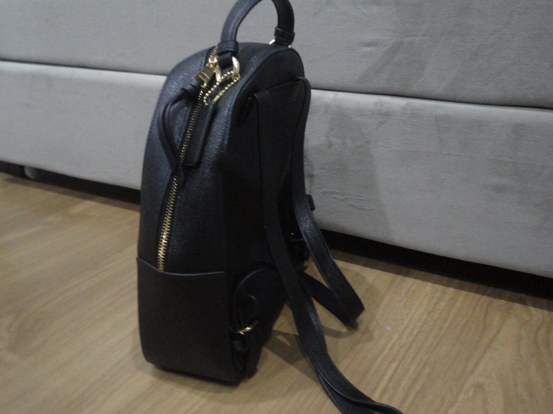 Authentic Coach Jordyn Black Leather Backpack (Category: Backpacks) located in Manila. Submitted by extras_bym (Listing ID 1470322397, Image 2). Description: - Brand: Coach - Material: Premium black pebble leather - Hardware: Elegant gold-tone hardware with gold logo plaque - Straps: Top handle and adjustable shoulder straps for comfort - Pockets: Front zippered pocket and main compartment with dual zip closure - Inclusions: Care booklet tag incl