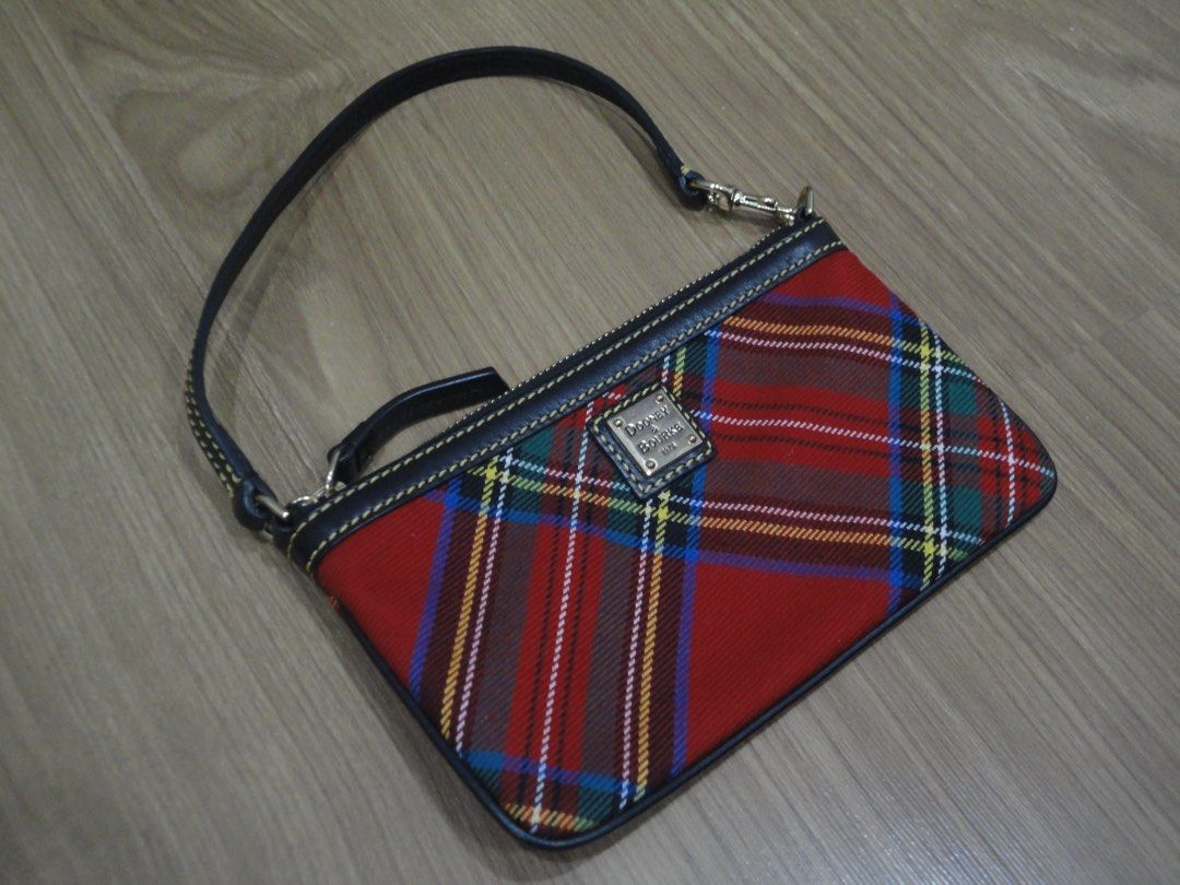 Authentic Dooney & Bourke Tartan Plaid Wristlet (Category: Luxury Bags & Wallets) located in Manila. Submitted by extras_bym (Listing ID 1470322059, Image 1). Description: - Brand: Dooney & Bourke - Design: Red tartan plaid with black leather trim and yellow contrast stitching - Hardware: Gold-tone with front metal logo plaque - Closure: Secure top zipper - Strap: Detachable black leather wrist strap - Size: Compact, ideal for cards, keys, and ph