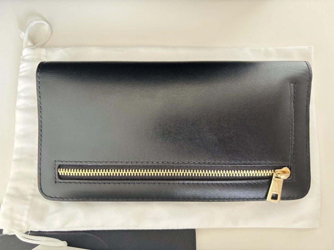 AUTHENTIC Furla Camelia XL Zip Around Slim Wallet (Category: Wallets & Card holders) located in Manila. Submitted by lxi16 (Listing ID 1470210744, Image 2). Description: - Brand: Furla - Material: Genuine black leather - Design: Slim zip-around with multiple card slots and compartments - Hardware: Elegant gold tone with front logo lettering - Condition: like new, used twice - Inclusions: Original box, tags, care booklet, and dust bag.
