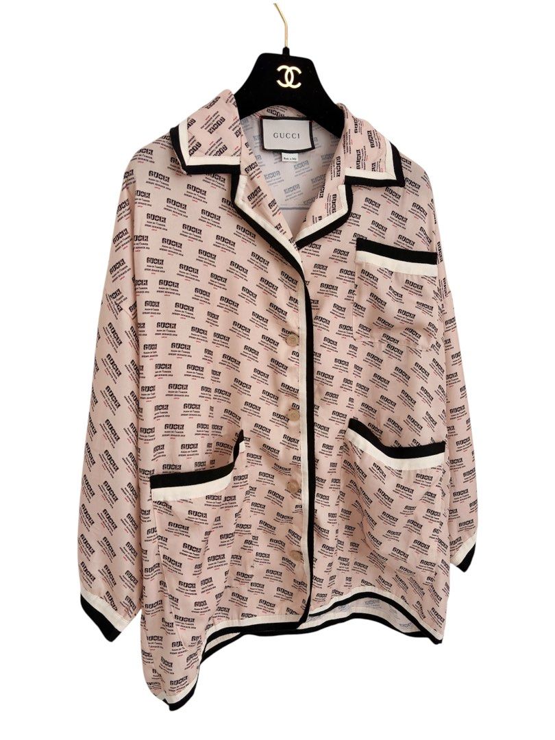 Authentic GUCCI Guccify Hypnotism Silk Blouse (Category: Luxury Apparel) located in Manila. Submitted by serendipitymanila (Listing ID 1470303604, Image 3). Description: - Brand: Gucci - Material: 100% luxurious pale pink silk - Design: All-over text print with a statement large 'Guccify Hypnotism' graphic on the back - Details: Contrast black and white piping on collar, placket, pockets, and hem - Fit: Relaxed, oversized fit with wide half-lengt