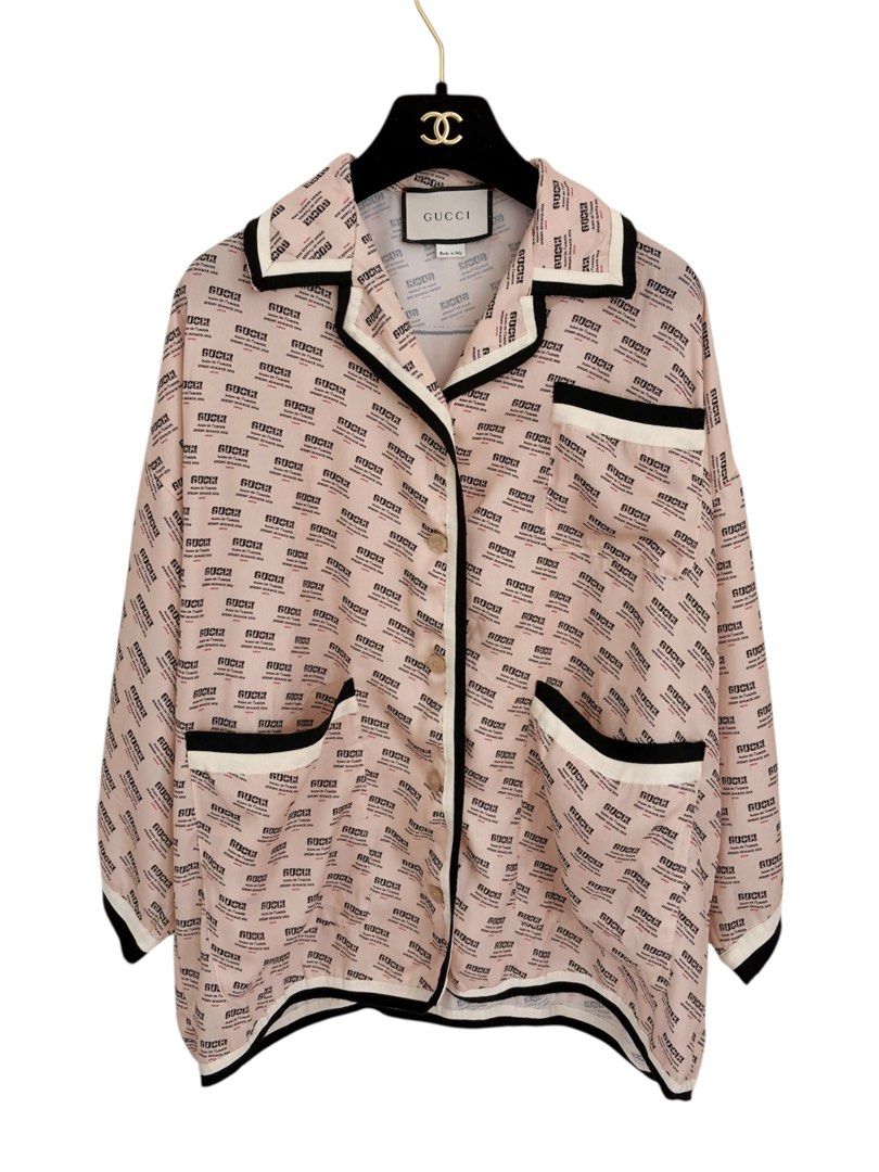 Authentic GUCCI Guccify Hypnotism Silk Blouse (Category: Luxury Apparel) located in Manila. Submitted by serendipitymanila (Listing ID 1470303604, Image 2). Description: - Brand: Gucci - Material: 100% luxurious pale pink silk - Design: All-over text print with a statement large 'Guccify Hypnotism' graphic on the back - Details: Contrast black and white piping on collar, placket, pockets, and hem - Fit: Relaxed, oversized fit with wide half-lengt