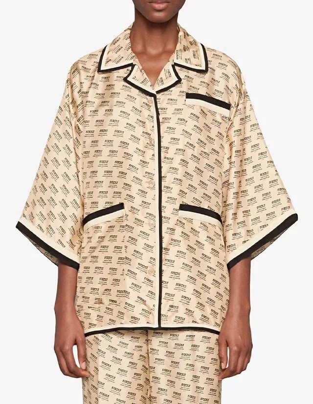 Authentic GUCCI Guccify Hypnotism Silk Blouse (Category: Luxury Apparel) located in Manila. Submitted by serendipitymanila (Listing ID 1470303604, Image 1). Description: - Brand: Gucci - Material: 100% luxurious pale pink silk - Design: All-over text print with a statement large 'Guccify Hypnotism' graphic on the back - Details: Contrast black and white piping on collar, placket, pockets, and hem - Fit: Relaxed, oversized fit with wide half-lengt