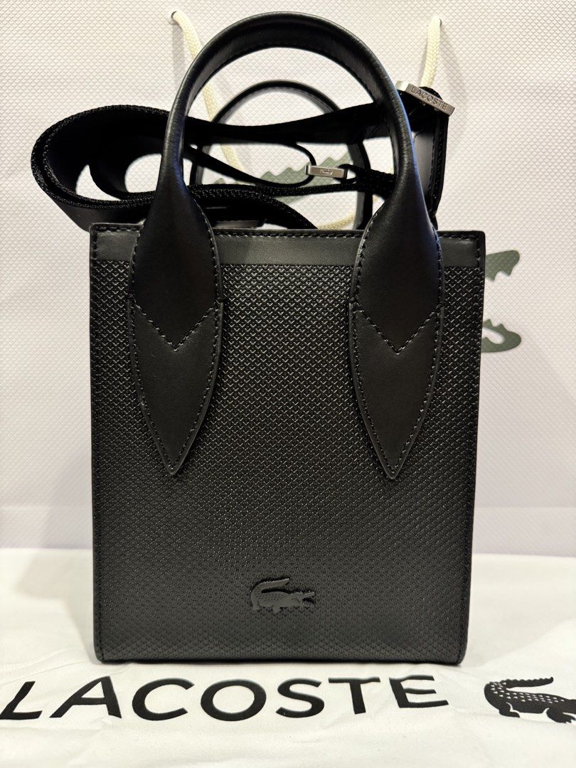 AUTHENTIC Lacoste Noir Mini Chantaco (Category: Sling Bags) located in Manila. Submitted by coco.junk (Listing ID 1470272084, Image 1). Description: FS: Authentic Lacoste Mini Chantaco Bag (Noir) Used ONLY ONCE - in pristine condition, good as brand new! • Color: Noir / Black • Bought for: P11,650 • Selling Price: P8,999 • RFS: Decluttering Product details • Chantaco embossed leather exterior • Adjustable strap: 85cm-140cm • 2 flat mesh compartme
