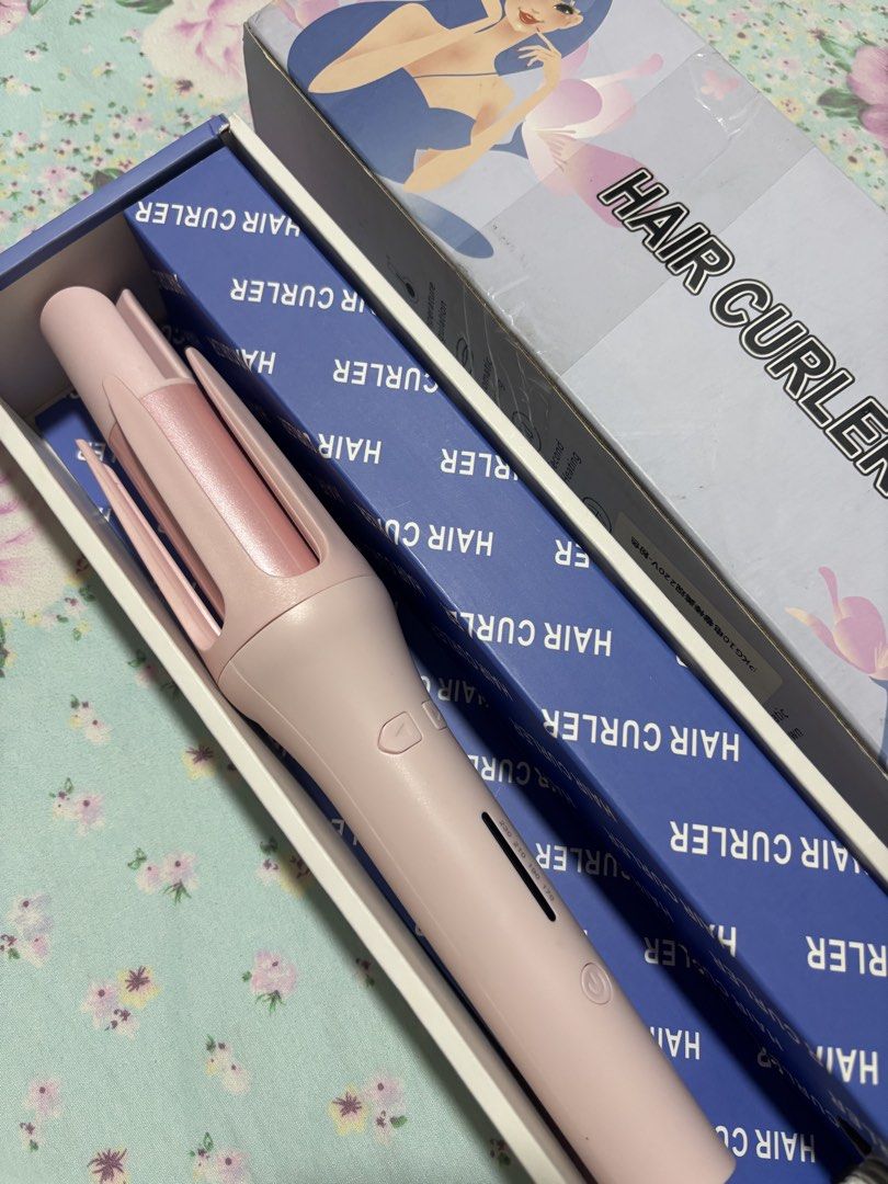 Automatic Hair Curler Pink Styling Tool with Box (Category: Hair) located in Quezon City. Submitted by ricalazo (Listing ID 1470178703, Image 1). Description: Automatic hair curler in soft pink. Model RD-2118, AC 110-220V. Temperature settings displayed on the handle. Includes original box and blue inner packaging. Great for styling waves and curls at home. Easy to use with directional buttons. Opened only. Never used since i have someone doing m