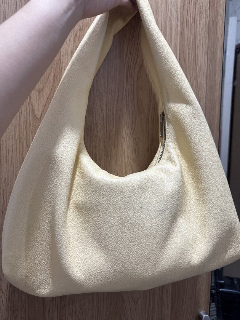 AZTRID Medium Hobo Bag Premium 2025 (Category: Shoulder Bags) located in Lipa City. Submitted by kelayaaa (Listing ID 1470259486, Image 2). Description: - Style: AZTRID medium hobo shoulder bag - Color: Cream - Material: Textured faux leather with a slouchy shape - Closure: Top zip closure - Details: Silver metal logo lettering near the bottom - Interior: Clean lining with one built-in zippered pocket - Condition: 9/10 used few times .