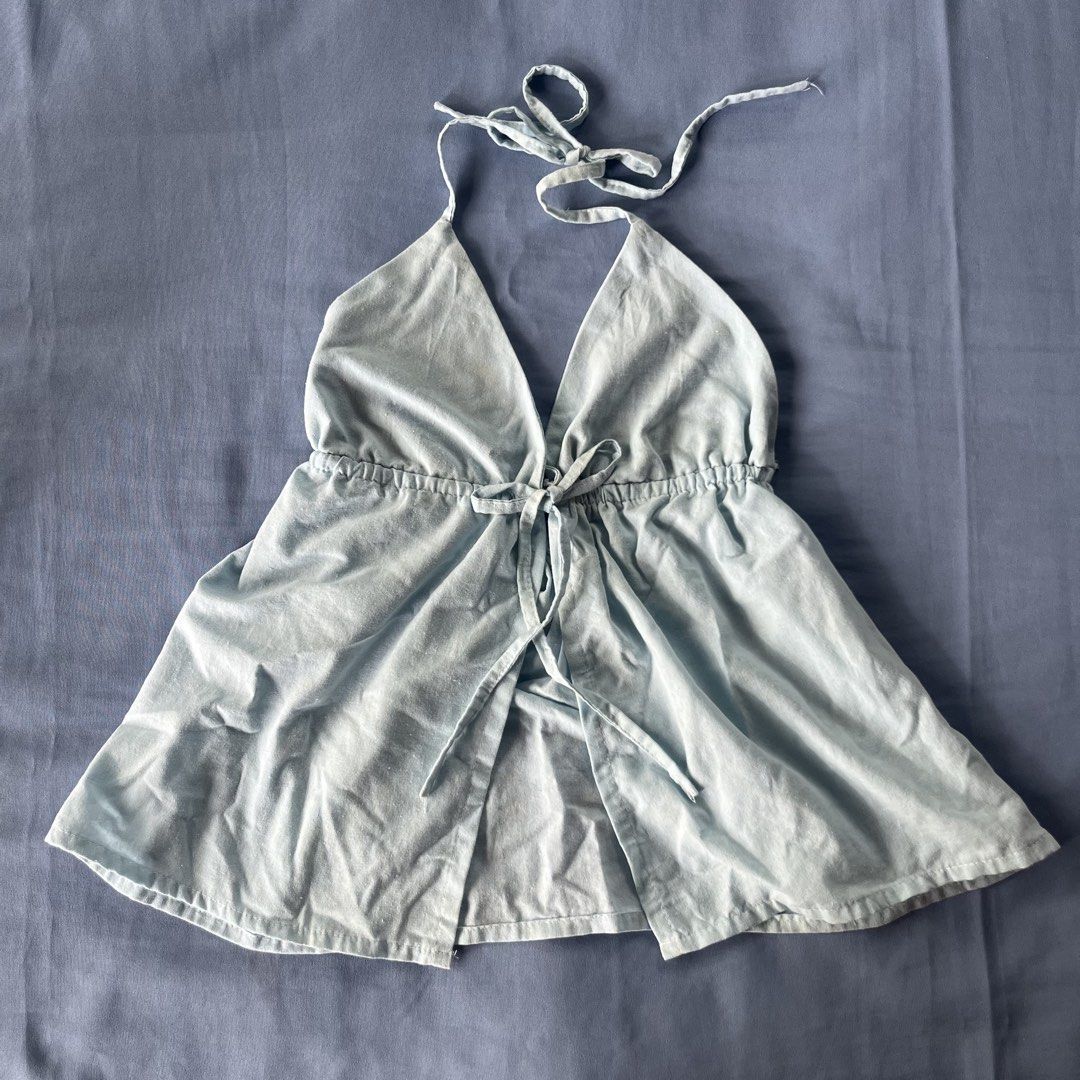 Baby blue halter top open front tie-up top (Category: Sleeveless) located in Bocaue. Submitted by frankie_1818 (Listing ID 1470190411, Image 2). Description: Fit: Adjustable tie straps at the neck and drawstring tie at the underbust - Style: Flowy flared hemline with a split front panel - Fabric: Lightweight and unlined, perfect for sunny days - worn once - minimal stain (removeable) Loc: UST Manila.