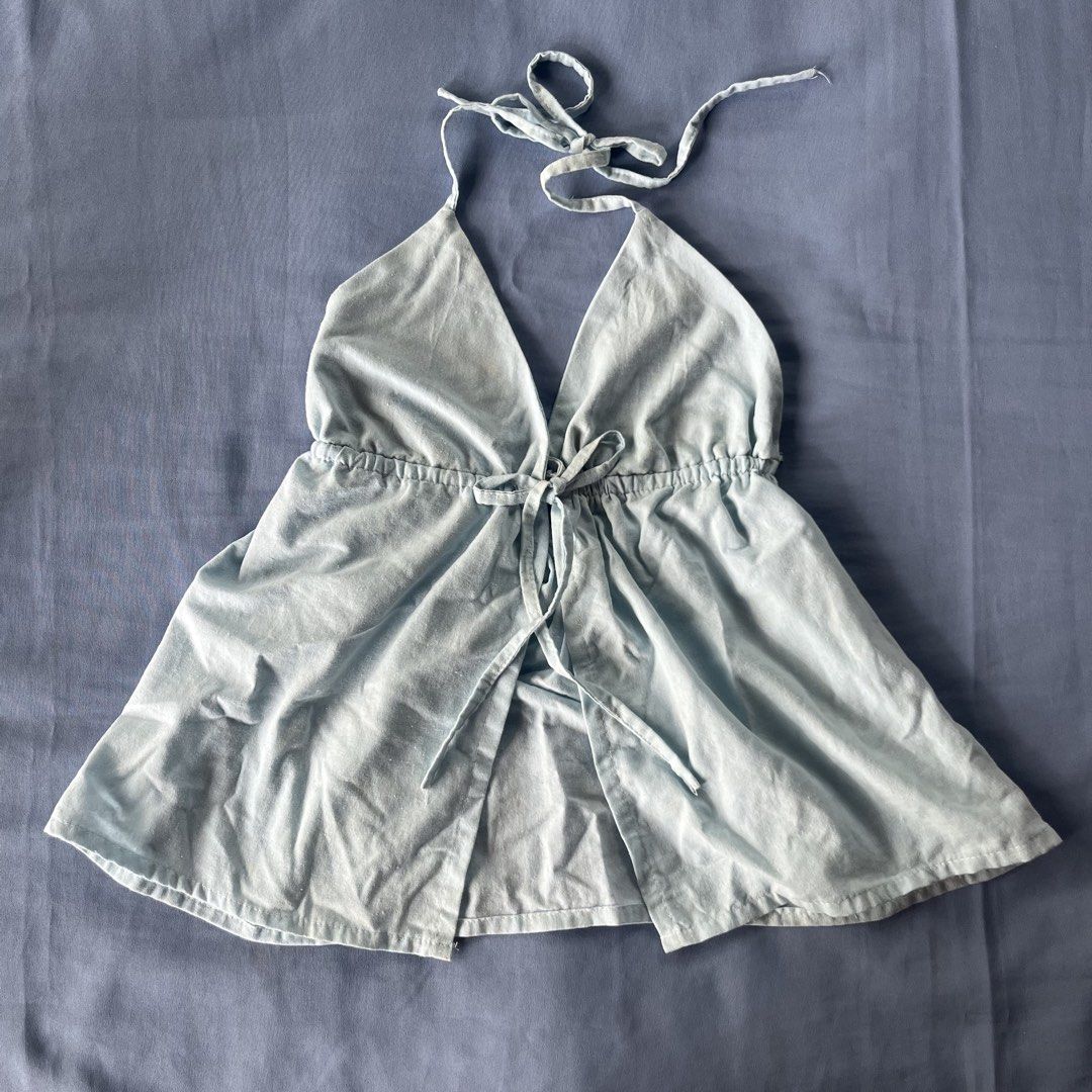 Baby blue halter top open front tie-up top (Category: Sleeveless) located in Bocaue. Submitted by frankie_1818 (Listing ID 1470190411, Image 1). Description: Fit: Adjustable tie straps at the neck and drawstring tie at the underbust - Style: Flowy flared hemline with a split front panel - Fabric: Lightweight and unlined, perfect for sunny days - worn once - minimal stain (removeable) Loc: UST Manila.