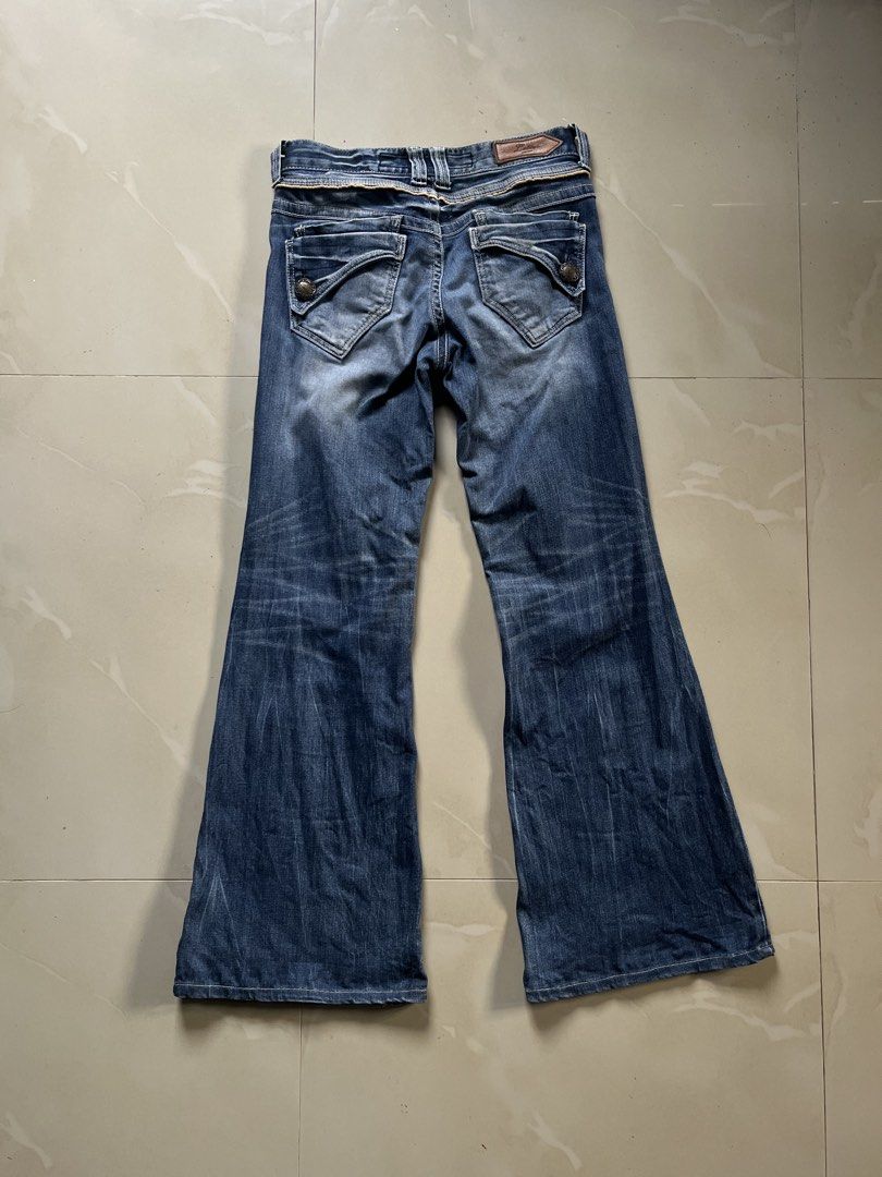 Back Number Blue Denim Flare Jeans (Category: Jeans) located in San Fernando. Submitted by p_thrifts (Listing ID 1470212545, Image 2). Description: - Brand: Back Number - Style: Bootcut flare jeans in classic blue wash - Fit: Mid-rise waist (measures approx. 14.5" across flat) - Details: Unique tan leather-trim front pockets, decorative back pockets, and stylish faded whiskering on thighs - Closure: Zipper fly with button closure - Condition: Gre