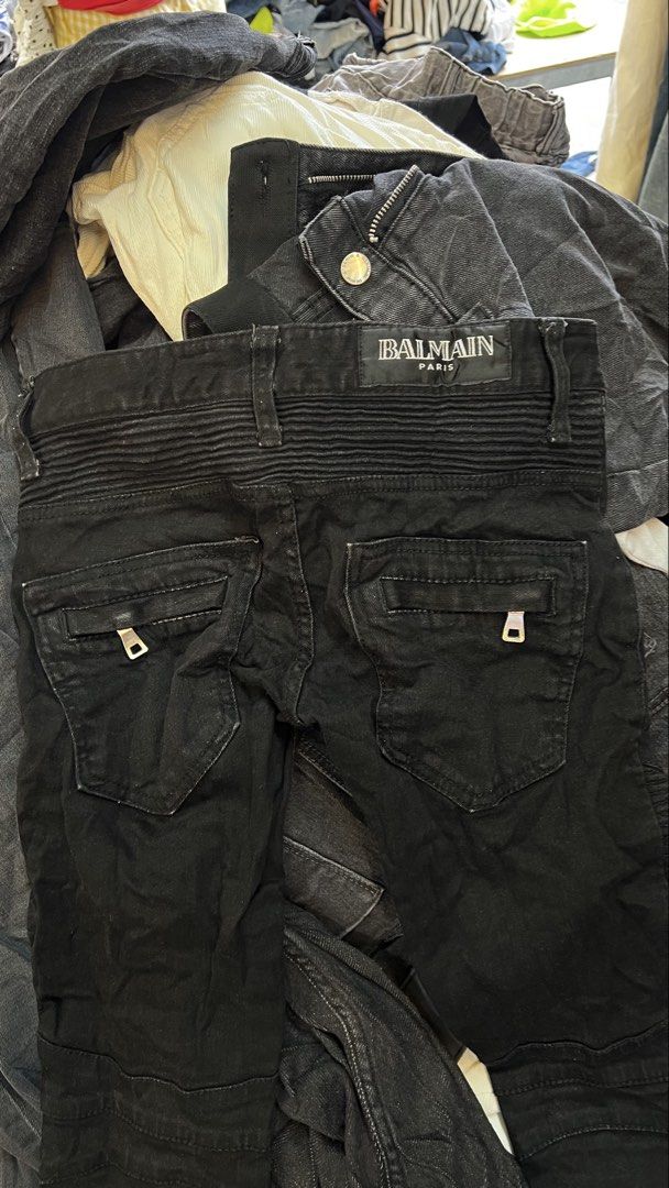 Balmain Paris Black Biker Jeans (Category: Jeans) located in Sagbayan (Borja). Submitted by thirftcartel (Listing ID 1470152162, Image 3). Description: - Brand: Balmain - Style: Black biker jeans with heavy moto aesthetic - Fit: Slim fit - Size: 25 (Tag indicated) - Material: Premium cotton denim - Key Features: Ribbed panels on knees and back waistband, functional zipped pockets on front and back - Care Instructions: Wash separately.