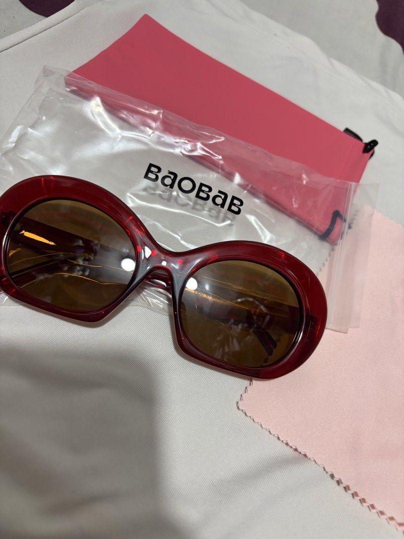 Baobab Elba in Cherry Red Sunglasses (Category: Sunglasses & Eyewear) located in Valenzuela. Submitted by cheaper_finds (Listing ID 1470152892, Image 1). Description: - Brand: Baobab - Model: Elba - Color: Cherry red thick acetate frames with brown tinted lenses - Condition: Brand new, never worn, still sealed in original packaging - Inclusions: Complete set with branded ziplock pouch, pink protective soft sleeve, and matching microfiber cleaning