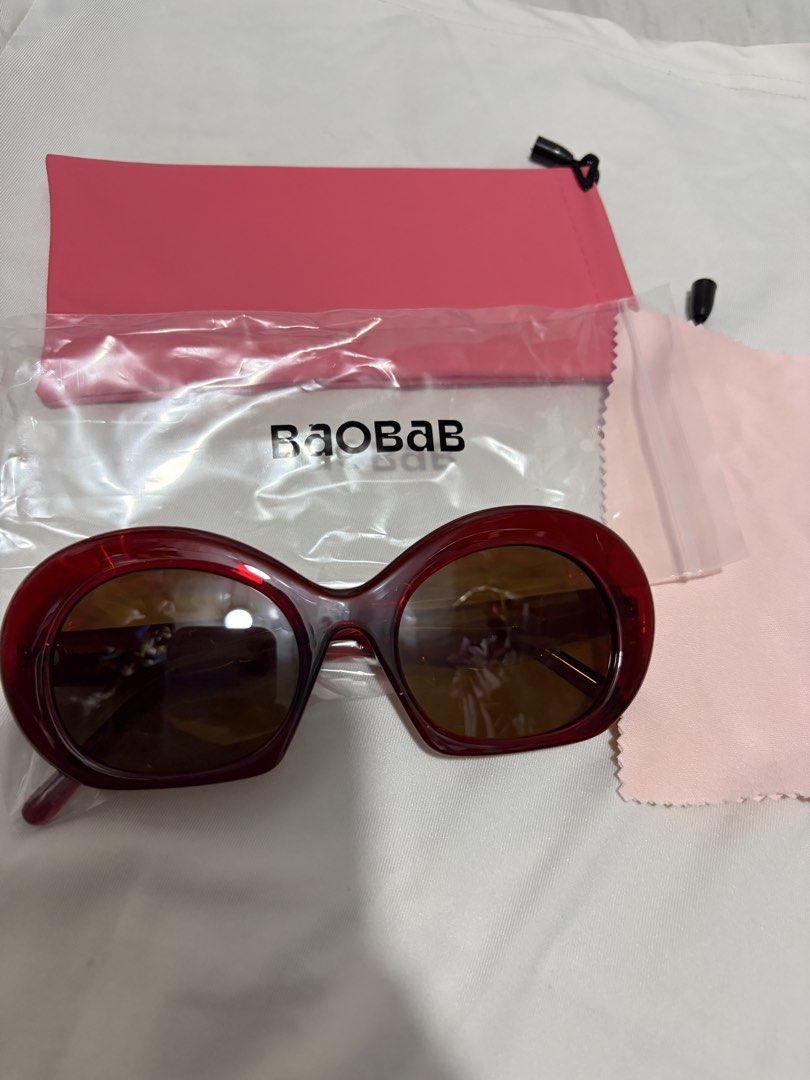 Baobab Elba in Cherry Red Sunglasses (Category: Sunglasses & Eyewear) located in Valenzuela. Submitted by cheaper_finds (Listing ID 1470152892, Image 2). Description: - Brand: Baobab - Model: Elba - Color: Cherry red thick acetate frames with brown tinted lenses - Condition: Brand new, never worn, still sealed in original packaging - Inclusions: Complete set with branded ziplock pouch, pink protective soft sleeve, and matching microfiber cleaning