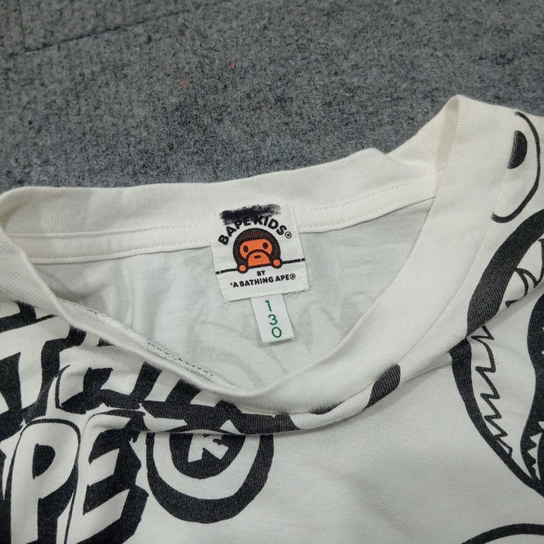 BAPE Kids Graffiti Pattern Tee (Category: Babies & Kids Fashion) located in Taguig. Submitted by sito. (Listing ID 1470327114, Image 3). Description: For sale! 📣 BAPE Kids Graffiti Pattern Tee Specs and measurements: • Length 23 inches • Width 18 inches Condition Details: • Excellent Condition • No issue • Color rate: 10/10 • Overall Condition: 10/10 Price: ~ ₱556 Transaction Details: Location: Upper Bicutan, Taguig City, Metro Manila, 1633 Paym