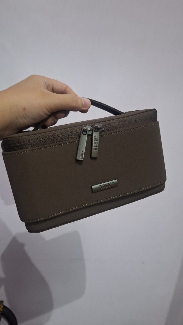 BASH flex organizer (Category: Accessory Holder, Box & Organizers) located in Caloocan City. Submitted by _mie3 (Listing ID 1470321840, Image 3). Description: - Brand: BASH manila - Color: Brown with clean dark brown interior lining - Structure: Sturdy, structured shape with a convenient side handle - Closures: Dual zipper opening with custom metallic pulls.