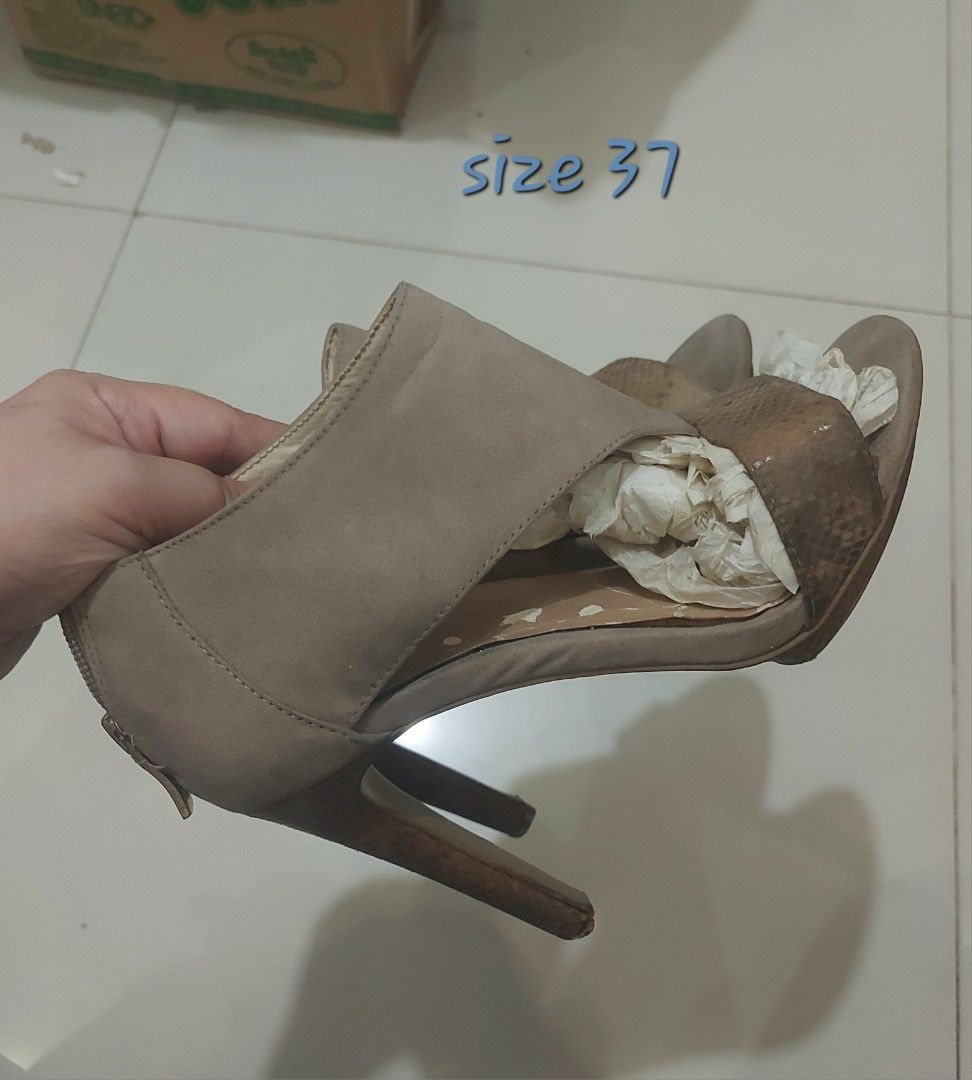 BCBGeneration Cutout Peep-Toe Stiletto Booties (Size 37) (Category: Heels) located in Pateros City. Submitted by foryoufindsph (Listing ID 1470212583, Image 1). Description: BCBGeneration Cutout Peep-Toe Stiletto Booties (Size 37) ​₱650 (Slightly negotiable for fast deals) ​Description: Elevate your outfit without breaking the bank! Chic and edgy authentic BCBGeneration high-heel booties featuring a stylish taupe suede upper, snakeskin-embossed f