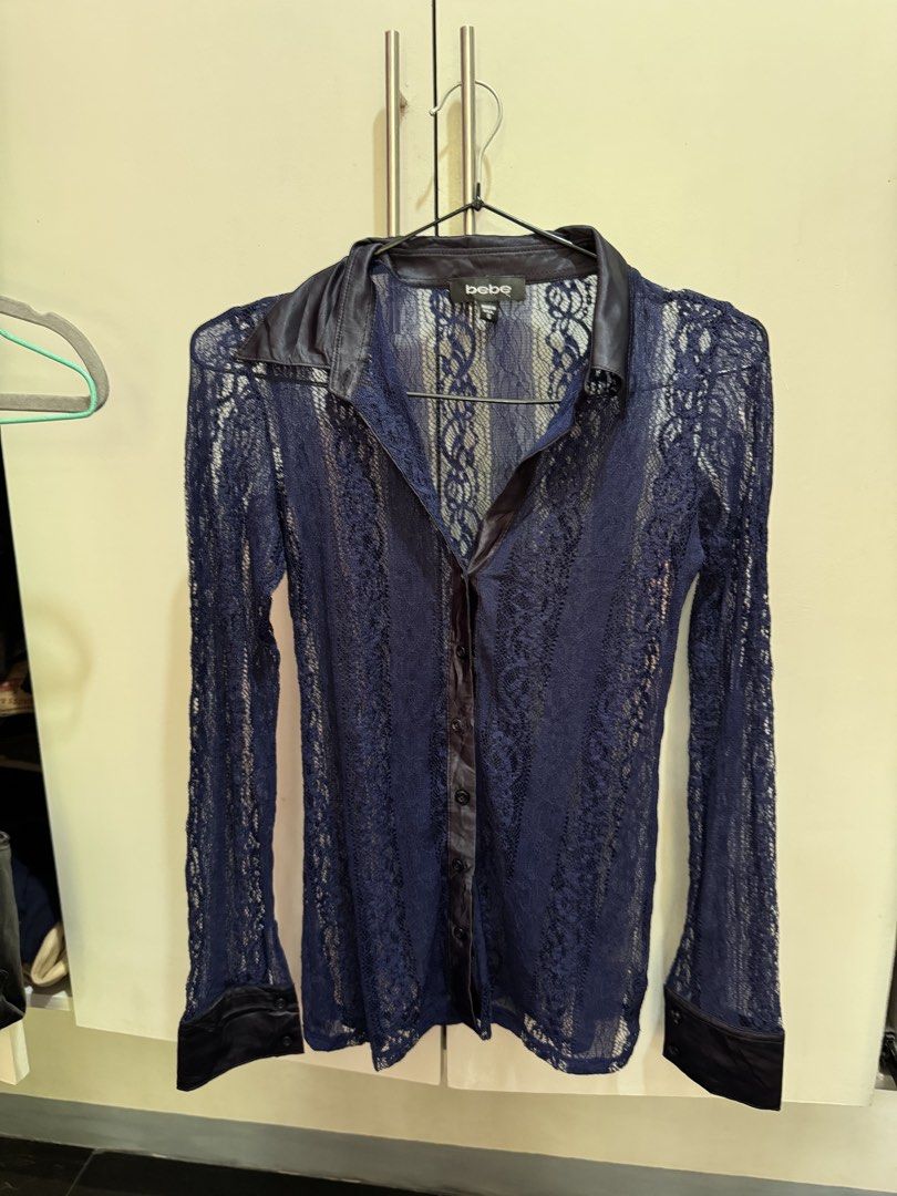 bebe Blue Lace Button-Down Long Sleeve Blouse Size S (Category: Longsleeves) located in Rosales. Submitted by thriftingismygame (Listing ID 1470183638, Image 1). Description: - Brand: Bebe - Style: Sheer blue lace button-down shirt - Details: Satin collar, placket, and cuffs, long sleeves - Condition: Size small tag attached (Brand New) - Origin: Made in USA - Best for: Layering or going out.