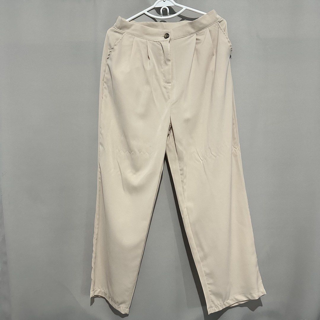 Beige High-Waisted Wide Leg Trousers (Category: Jeans) located in General Mariano Alvarez. Submitted by shopyannie (Listing ID 1470163641, Image 1). Description: - Color: Classic beige - Fit: Wide leg cut with front pleats - Closure: Single button - Pockets: Functional side pockets - Fabric: Lightweight and comfortable - Style: Ideal for office wear and smart casual outfits - Easy to match with various tops.