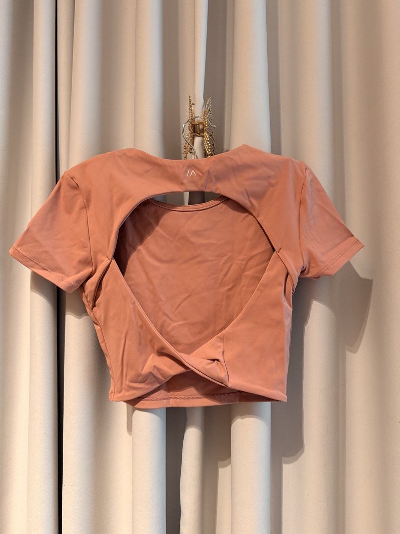 Bench Active Pink Activewear Crop Top with Open Back (Category: Activewear) located in Taguig. Submitted by regalbbb (Listing ID 1470323300, Image 2). Description: Original Price: Can't remember RFS: Decluttering Condition: No flaws and never used - Color: Pink - Fit: Short-sleeve crop top - Neckline: Round front, big cutout with twisted hem in the back - Material: Soft and stretchy fabric - Details: Subtle brand logo printed near the back neckli