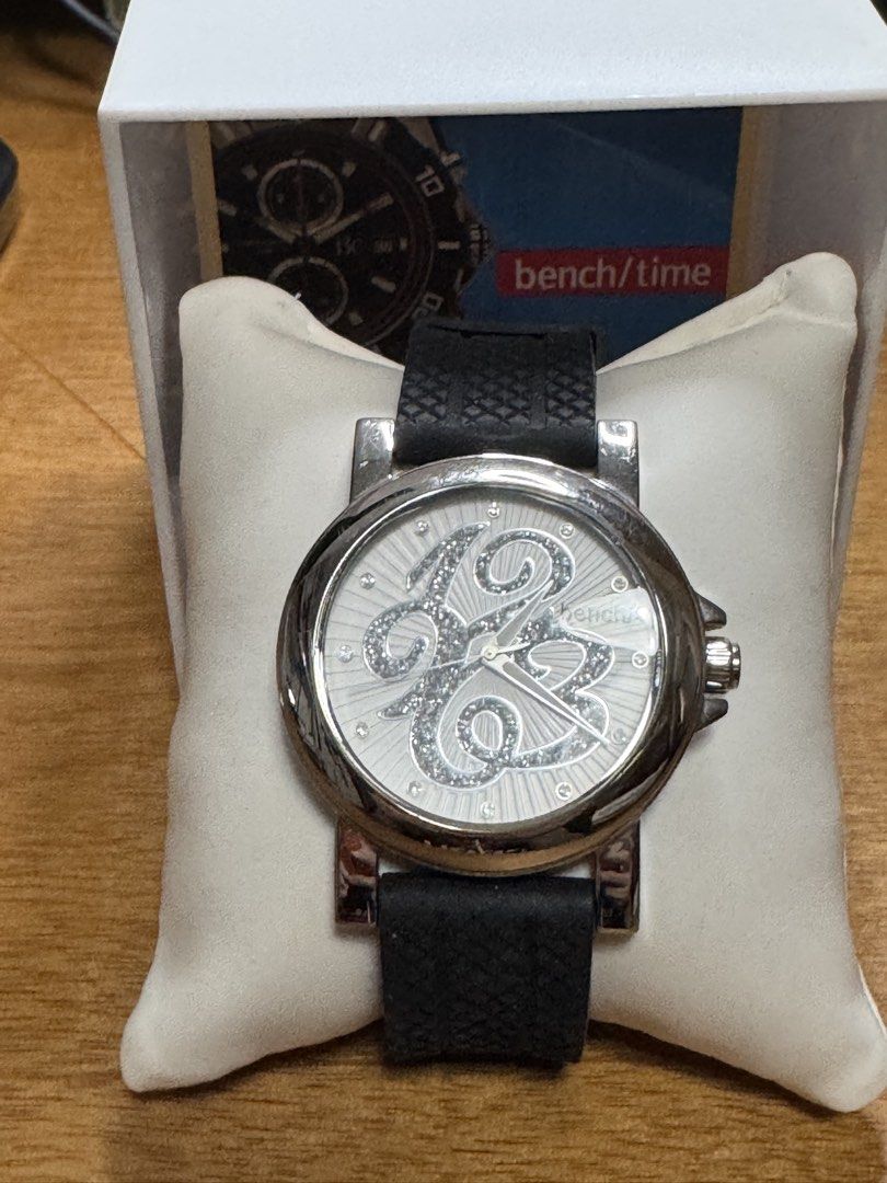 Bench/Time Watch with Box (Category: Women's Watches) located in Valenzuela. Submitted by wisetree_18aeb6 (Listing ID 1470197126, Image 2). Description: - Brand: Bench/Time wristwatch - Design: Silver bezel with a white dial featuring large, sparkly numbers - Strap: Rubber Black strap - not original - Movement: Battery-powered analog movement - Condition:slightly used - Inclusions: Original white box and display pillow - Battery newly replaced.
