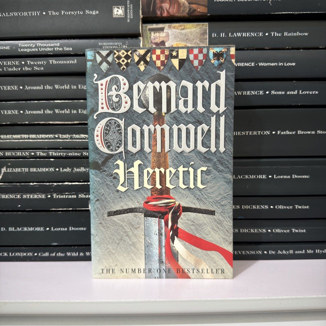 Bernard Cornwell Heretic Novel Paperback (Category: Storybooks) located in Lingayen. Submitted by readwjane (Listing ID 1470200028, Image 1). Description: - Title: Heretic by Bernard Cornwell - Format: Paperback edition featuring striking sword graphic and #1 bestseller tag - Genre: Historical fiction and medieval adventure - Condition: Well-maintained and properly stored on a shelf - Perfect for fans of epic historical drama.
