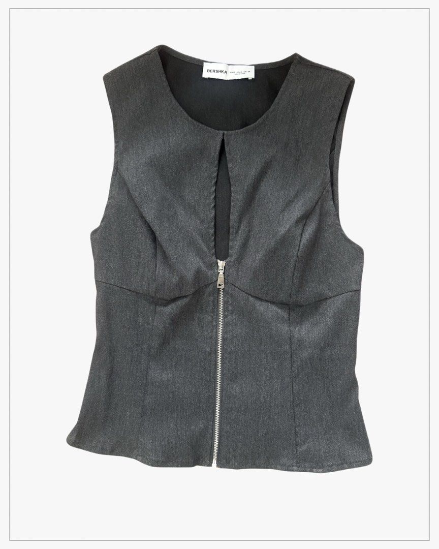 Bershka Grey Front Zip Sleeveless Top (Category: Sleeveless) located in Manila. Submitted by zealbear-54d3 (Listing ID 1470166284, Image 1). Description: - Brand: Bershka - Color: Dark grey with a subtle textured finish - Style: Sleeveless, fitted cut with structural front seams - Details: Front center zipper with a chic neckline cutout keyhole - Closure: Convenient back zipper - Condition: Excellent, clean interior lining.