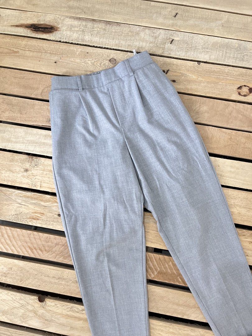 Bershka Grey Trousers Size M (Category: Jeans) located in Santa Rosa. Submitted by thrifty_bev (Listing ID 1470293885, Image 2). Description: - Brand: Bershka - Size: Medium (M) - Color: Clean light grey - Design: High-waisted with pleated front and turned-up hem cuffs - Comfort: Elastic waistband at the back - Pockets: Two back pockets included - Origin: Made in Turkey - Condition: Excellent, versatile for casual or office wear.