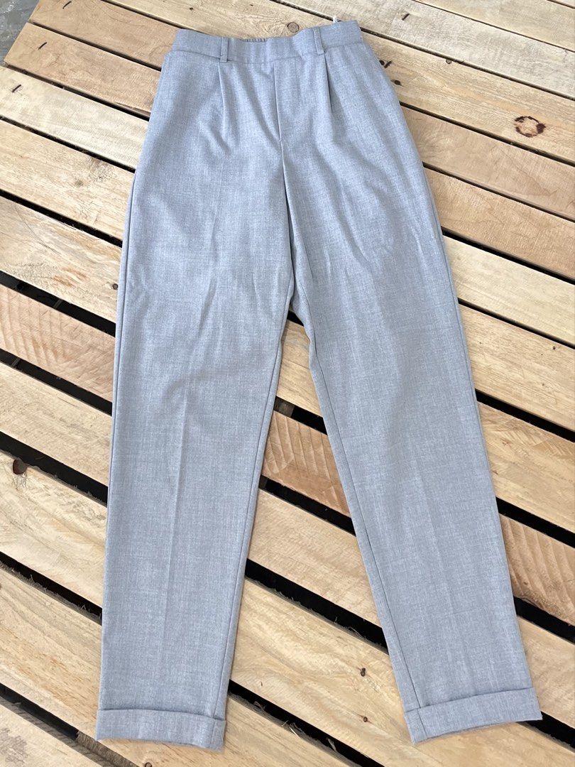 Bershka Grey Trousers Size M (Category: Jeans) located in Santa Rosa. Submitted by thrifty_bev (Listing ID 1470293885, Image 3). Description: - Brand: Bershka - Size: Medium (M) - Color: Clean light grey - Design: High-waisted with pleated front and turned-up hem cuffs - Comfort: Elastic waistband at the back - Pockets: Two back pockets included - Origin: Made in Turkey - Condition: Excellent, versatile for casual or office wear.