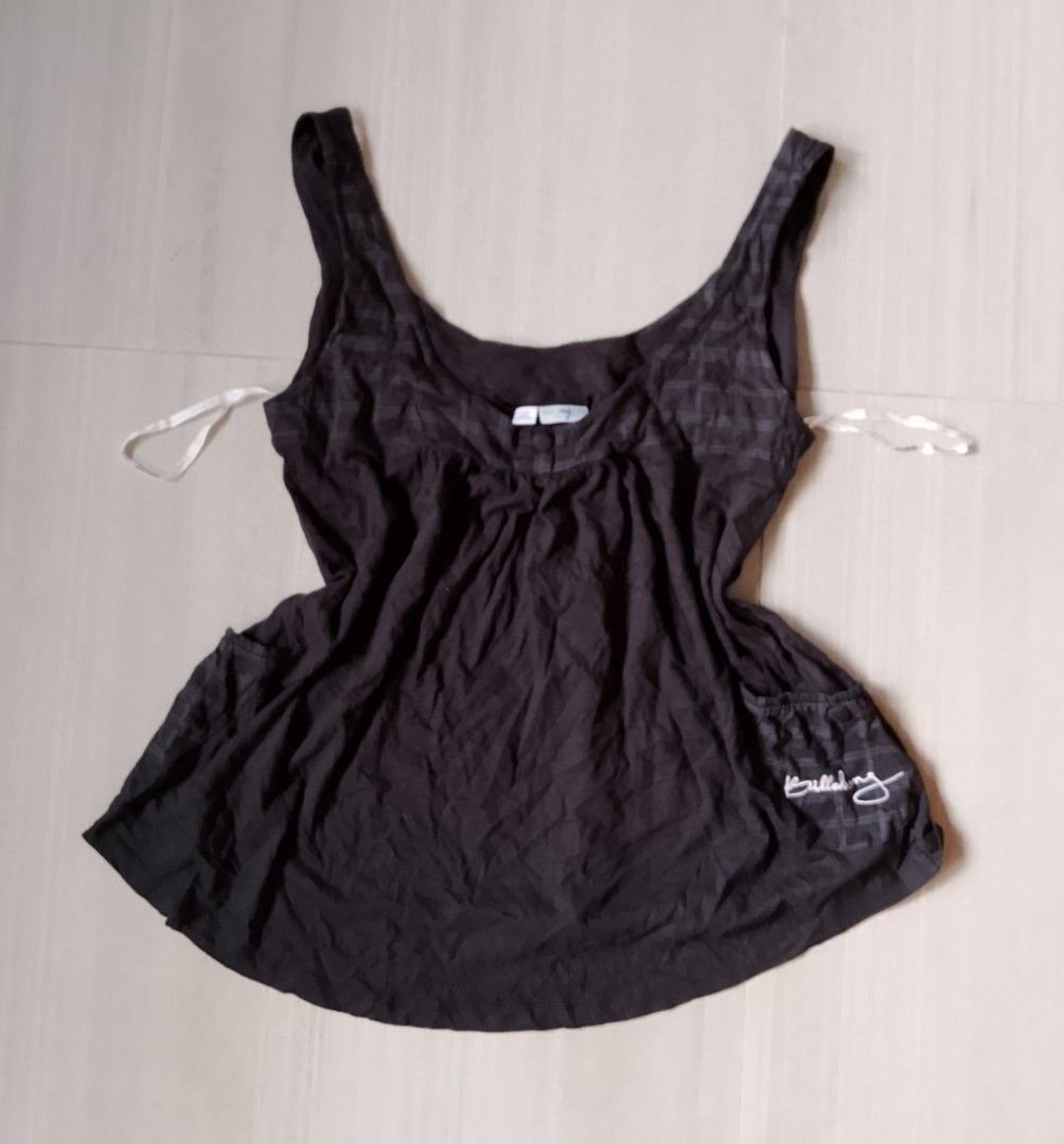 Billabong Black Tank Top Size 12 (Category: Sleeveless) located in Manila. Submitted by keencrystal.595c28 (Listing ID 1470252943, Image 1). Description: - Brand: Billabong - Size: 12 - Material: 100% lightweight cotton (great for warm weather) - Color: Classic black - Design: Subtle check pattern, scooped neckline, and gathered bodice with button detail - Branding: Embroidered logo near the hem - Condition: Excellent / Ready to wear.