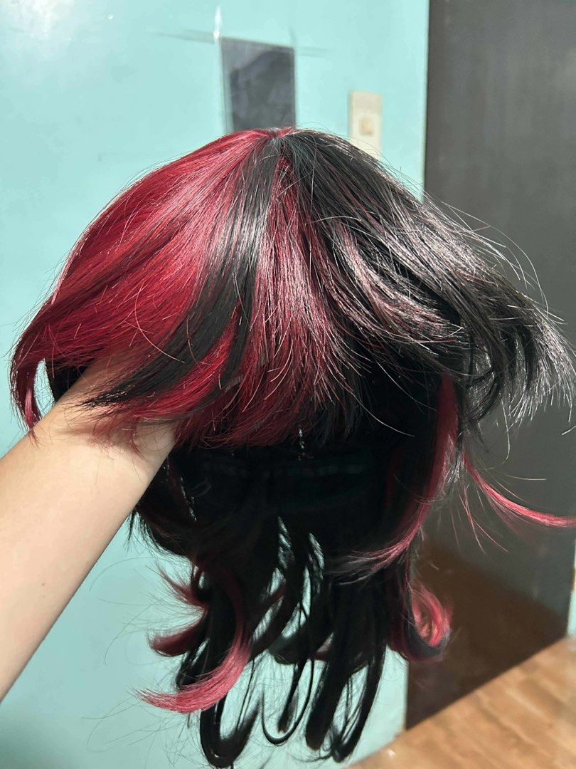 Black and Red Highlights Layered Wig (Category: Hair Accessories) located in Manila. Submitted by lovely.453 (Listing ID 1470234320, Image 2). Description: - Style: Layered medium-to-long wig with feathered ends - Color: Black base with vibrant red streaks - Material: High-quality synthetic fiber - Interior: Clean cap for comfortable wear - Versatile: Great for everyday styling, parties, and cosplay events - Condition: Ready to wear.