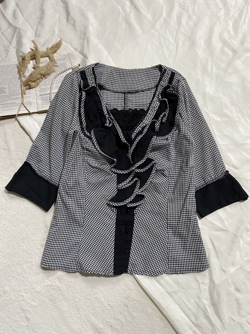 Black and White Gingham Ruffle Blouse Small 35 (Category: Blouses) located in Poro. Submitted by joyceyuu (Listing ID 1470184254, Image 1). Description: - Style: Black & white gingham with solid black panels - Details: Ruffle trim down the front, button fastening - Sleeves: Half sleeves with contrast black cuffs - Versatility: Great for casual outings or smart-casual office wear - Pairing: Easy to match with skirts or trousers.