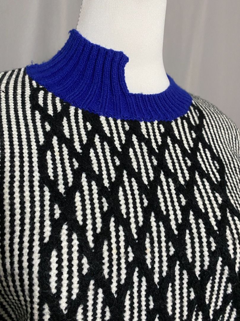 Black and white knitted sweater with multicolor hem (Category: Longsleeves) located in Las Pinas. Submitted by ipickyou (Listing ID 1470288262, Image 3). Description: Unwashed Condition: 10/10 𝗠𝗲𝗮𝘀𝘂𝗿𝗲𝗺𝗲𝗻𝘁𝘀 𝘄𝗵𝗲𝗻 𝗹𝗮𝗶𝗱 𝗳𝗹𝗮𝘁: -Shoulder to shoulder: 15 1/2” -Armpit to armpit: 17” -Length: 22” .