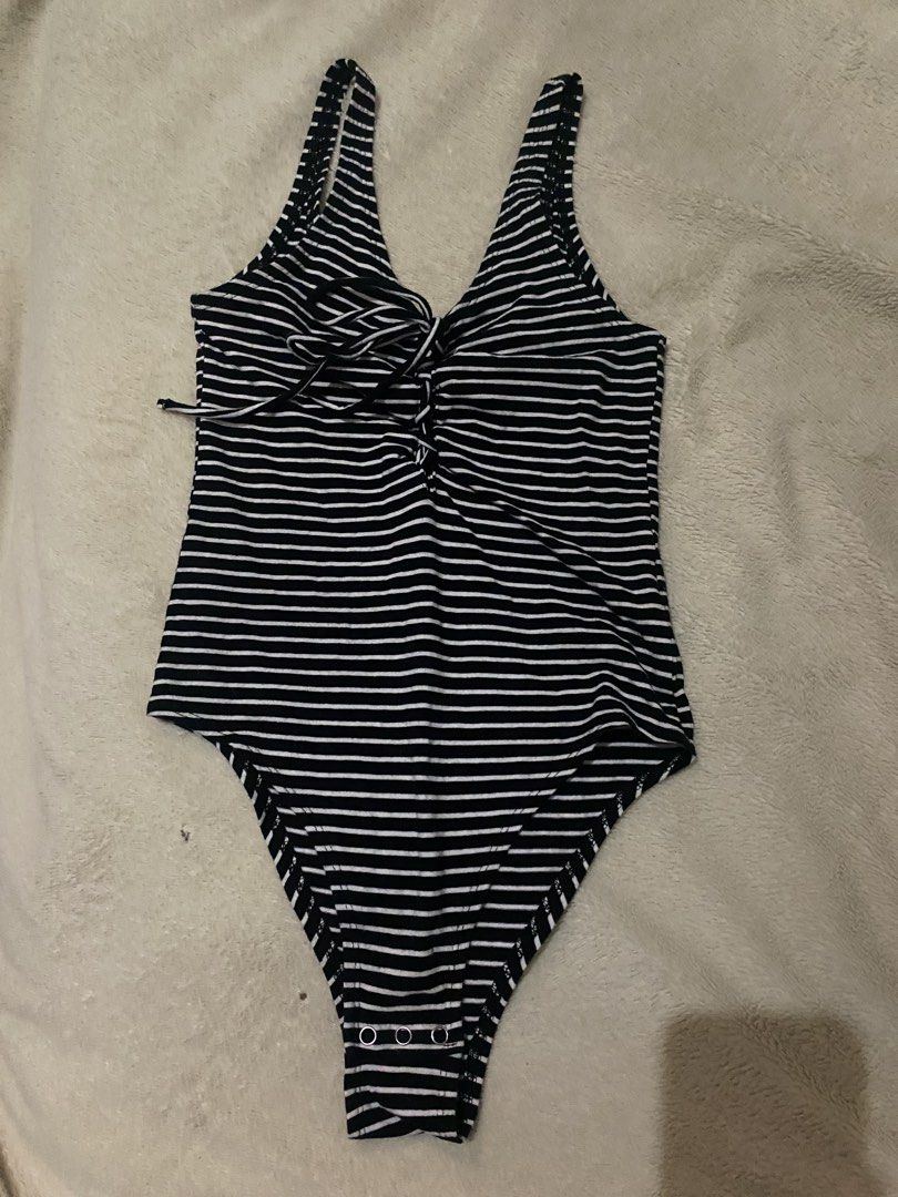 Black and White Striped Bodysuit with Lace-up Front (Category: Blouses) located in Alaminos. Submitted by chichiyr (Listing ID 1470172042, Image 1). Description: NEGOTIABLE PO YUNG PRICE!! Dm for inquiries - Classic black and white striped design - Deep V-neck with adjustable lace-up chest tie - Sleeveless with comfortable wide straps - Convenient bottom snaps closure - Super stretchy and comfortable fabric - Versatile basic top for jeans or skir