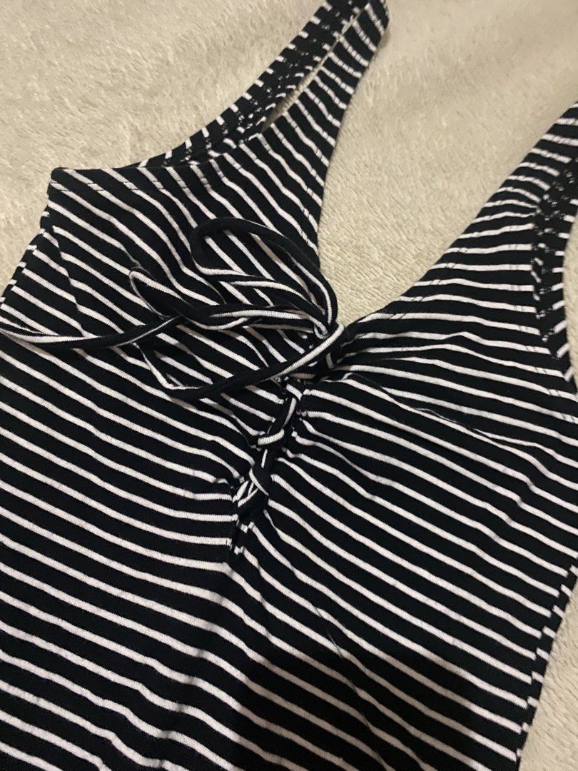 Black and White Striped Bodysuit with Lace-up Front (Category: Blouses) located in Alaminos. Submitted by chichiyr (Listing ID 1470172042, Image 2). Description: NEGOTIABLE PO YUNG PRICE!! Dm for inquiries - Classic black and white striped design - Deep V-neck with adjustable lace-up chest tie - Sleeveless with comfortable wide straps - Convenient bottom snaps closure - Super stretchy and comfortable fabric - Versatile basic top for jeans or skir