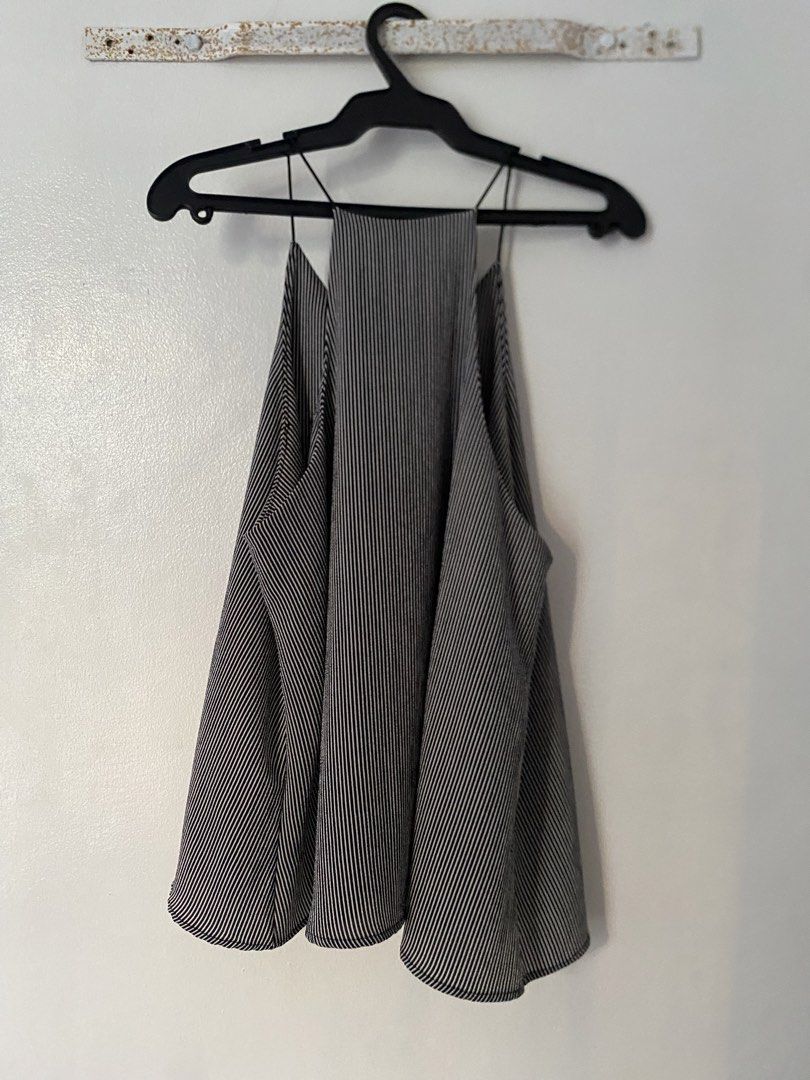 Black and White Striped Spaghetti Strap Tank Top (Category: Sleeveless) located in Caloocan City. Submitted by juliana_25a (Listing ID 1470232997, Image 2). Description: - Style: Black and white vertical pinstripe tank top - Design: Thin spaghetti straps, high halter neckline, and flowing relaxed hem - Material: Lightweight, breathable pleated fabric (super comfortable for warm weather).
