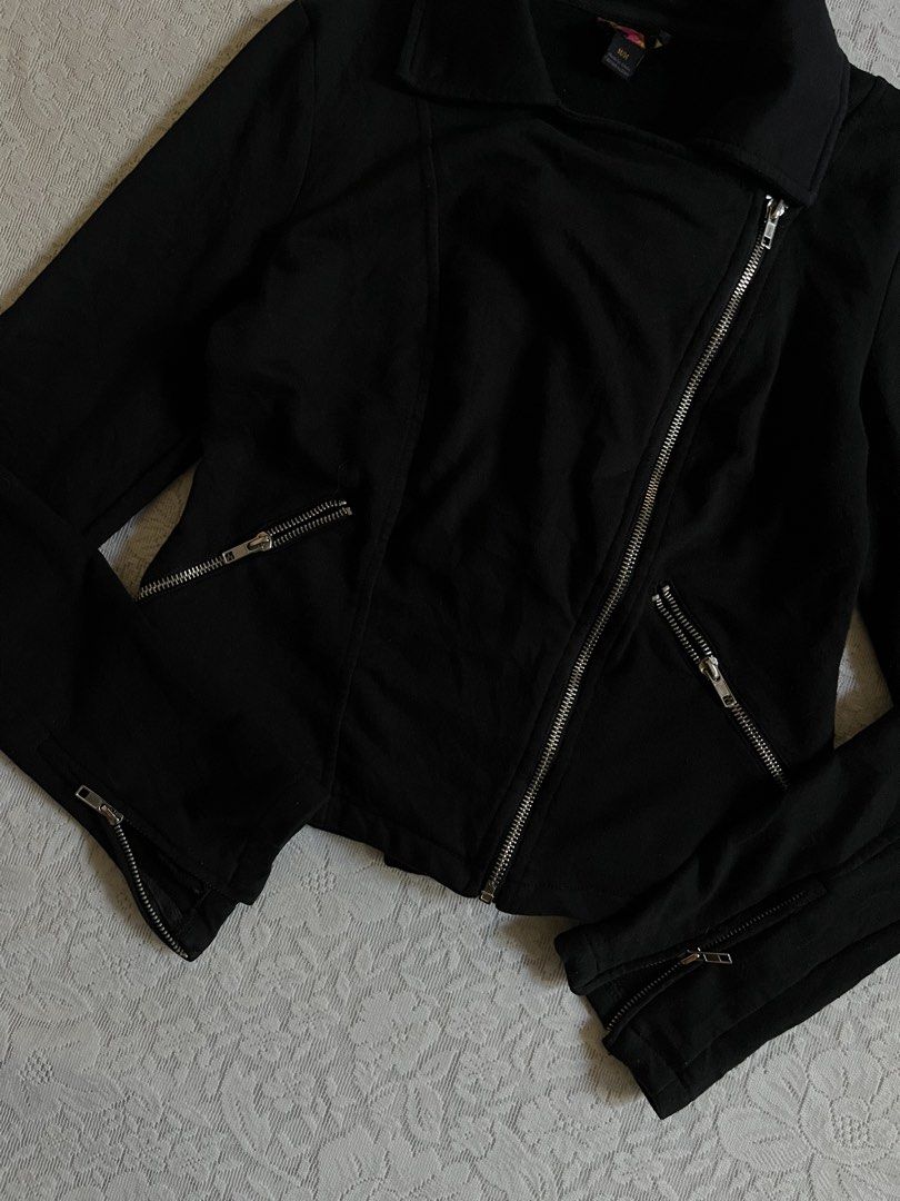Black Biker Jacket Moto Asymmetrical Zip Size M (Category: Coats, Jackets and Outerwear) located in Baguio. Submitted by dutefinds (Listing ID 1470347579, Image 3). Description: - Color: Solid black - Size: Medium - Material: Comfortable cotton or cotton-blend - Design: Asymmetrical front zipper with a collared neckline and structured fit - Details: Silver hardware, diagonal front pockets, and zippered cuffs - Style: Versatile and easy to match w