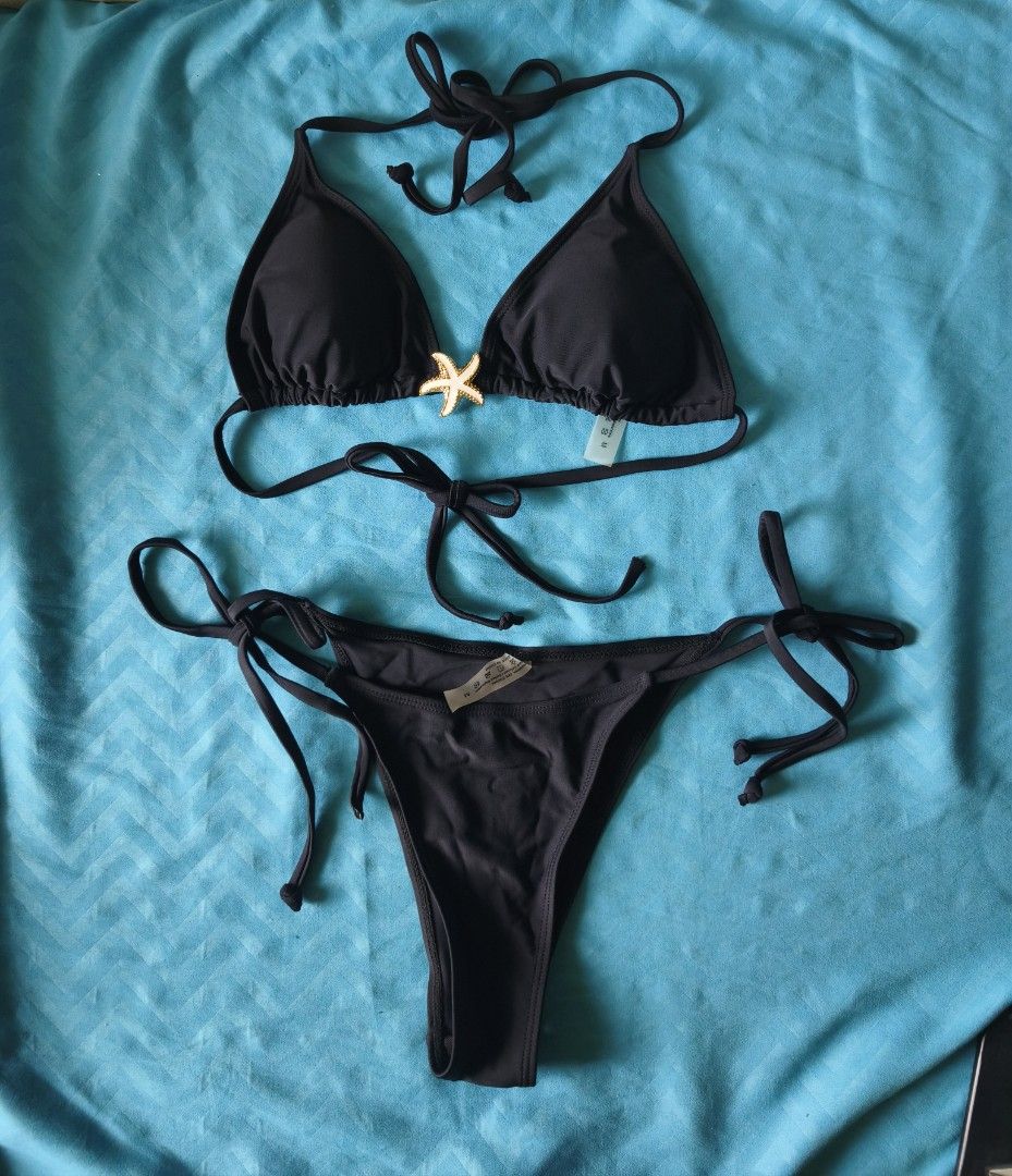 Black Bikini Set and 1 Free Bikini Bottom (Category: Bikinis & Swimsuits) located in Legazpi City. Submitted by maryyy08 (Listing ID 1470168141, Image 2). Description: - Size: XS-M - Color: Bikini Black Set and Blue Violet Bikini Bottom - Style: Halter neck with standard triangle cut - Details: Features a decorative gold and white starfish charm between the cups - Fit: Adjustable ties at the neck and back - Condition: Never used, thrifted as prel