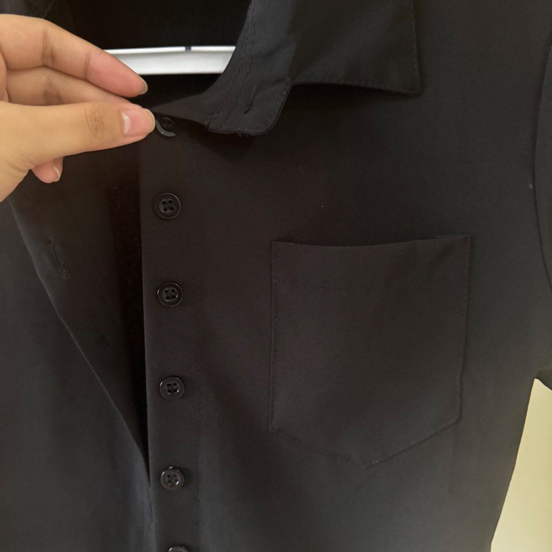 Black Button Shirt Top with a front pocket (Category: Shirts) located in Mandaluyong City. Submitted by cloudycloset09 (Listing ID 1470168529, Image 2). Description: Used several times but I would say is still in good condition. All 7 buttons are in tact, no permanent flaws. This can fit XS-MEDIUM frame. .