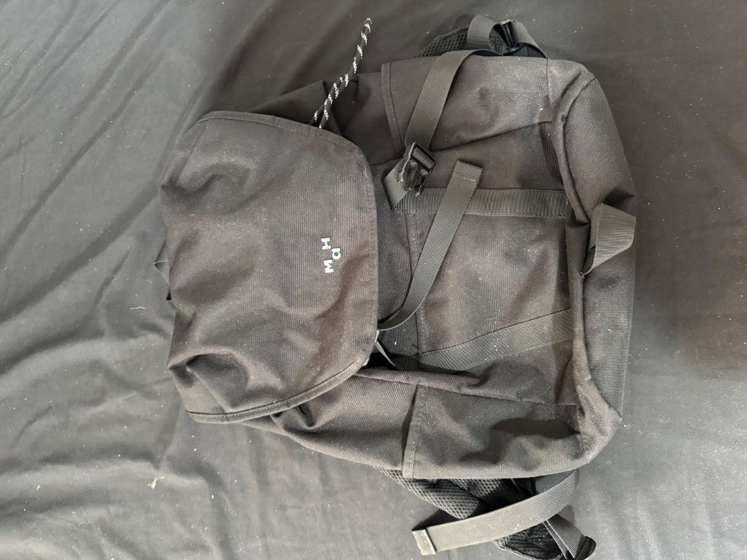 Black Canvas Backpack with Front Flap and Straps (Category: Backpacks) located in Caloocan City. Submitted by buritomma (Listing ID 1470157955, Image 1). Description: - Color: Solid black - Material: Sturdy, durable canvas - Closure: Flap closure with front buckle detail - Straps: Comfortable, adjustable shoulder straps - Pockets: Front flap pocket with subtle embroidered branding - Style: Minimalist everyday carry bag.
