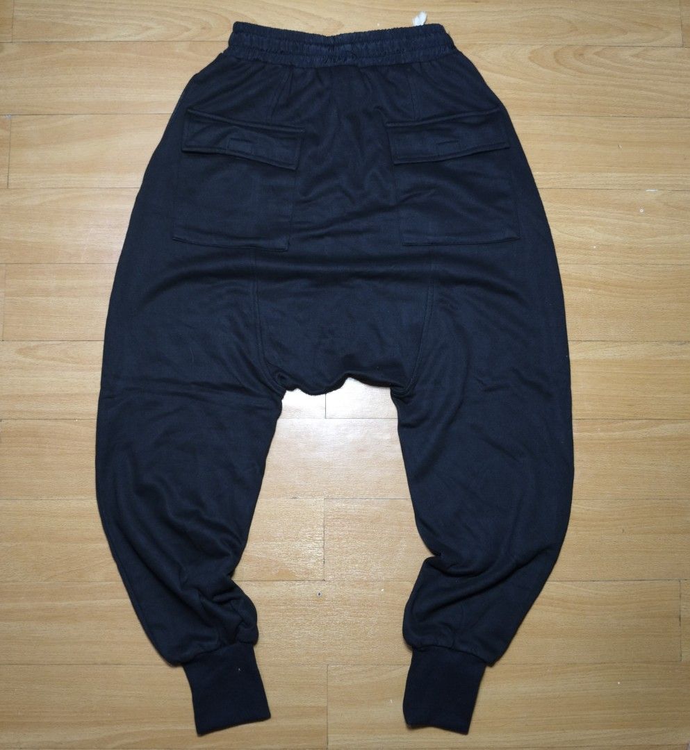 Black Drop Crotch Harem Sweatpants with Cargo Pockets (Category: Joggers) located in Manila. Submitted by usedtobeyours26 (Listing ID 1470329041, Image 2). Description: - Color: Black - Style: Drop-crotch harem pants with a relaxed silhouette and tapered legs - Material: Soft jersey knit cotton - Waistband: Elastic with an adjustable white drawstring - Pockets: Two utility cargo pockets on the back - Cuffs: Ribbed at the ankles - Perfect for: Str