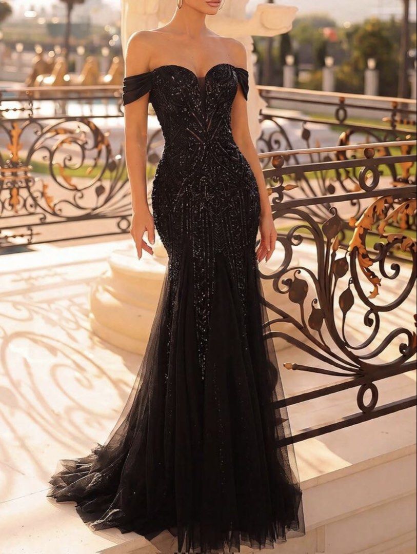 Black Evening Gown (Category: Evening dresses & gowns) located in Muntinlupa City. Submitted by eksamano (Listing ID 1470346680, Image 1). Description: - Color: Black - Style: Mermaid gown with layered tulle skirt and small train - Details: Covered in glittery sequins and intricate beadwork - Neckline: Off-the-shoulder with ruched fabric, sweetheart cut, and sheer mesh center insert - Closure: Adjustable lace-up corset back - Fit: Body-hugging si