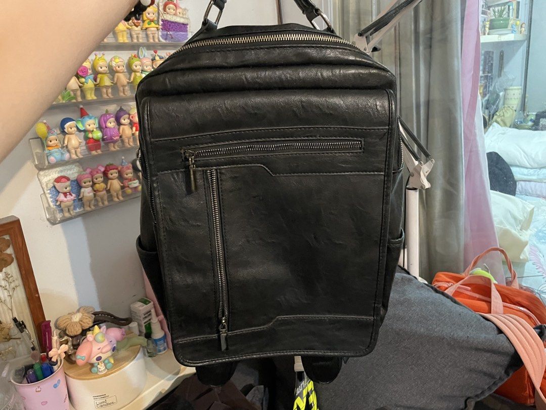 Black faux leather backpack with multiple zipper pockets (Category: Backpacks) located in Pasig City. Submitted by raeraesold333 (Listing ID 1470305540, Image 1). Description: - Material: Premium black faux leather - Storage: Multiple compartments including a vertical zip pocket, horizontal zip compartment, and wide-opening main section - Laptop Friendly: Includes a secure, padded laptop sleeve with strap closure - Extra Storage: Convenient inner