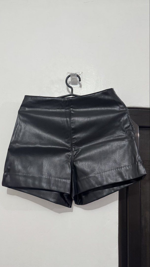 Black Faux Leather Shorts (Category: Shorts) located in Muntinlupa City. Submitted by maraaalpz (Listing ID 1470275237, Image 1). Description: - Color: Black - Material: Smooth faux leather - Fit: Regular fit with a flattering high-waist cut - Details: Clean stitching on folded cuffs and a simple zip closure - Style: Versatile basic piece, perfect for casual weekends or nights out.