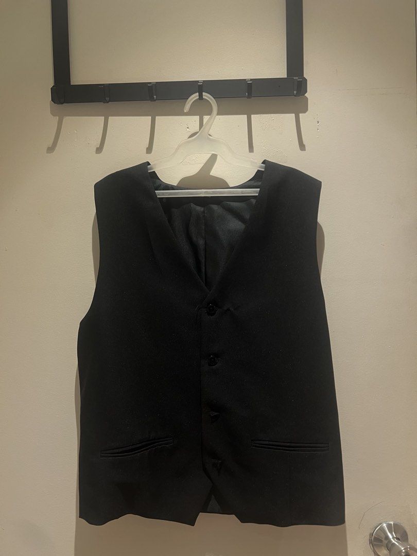 Black Formal Vest (Category: Vests) located in Malabon City. Submitted by chrsgns (Listing ID 1470222408, Image 1). Description: - Color: Classic Black - Design: V-neck with a clean, sharp shape - Closure: Four-button front - Pockets: Two functional welt pockets near the hem - Interior: Fully lined for comfort and structure - Style: Versatile piece ideal for formal events, weddings, or smart workwear.