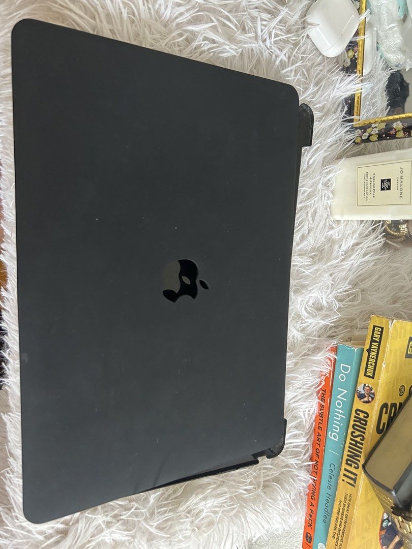 Black Macbook Case with Apple Logo Cutout (Category: Cases & Sleeves) located in Manila. Submitted by la_apparel (Listing ID 1470161190, Image 1). Description: - Sleek black matte finish with Apple logo cutout - Easy snap-on installation for daily protection against scratches and bumps - Standard folio style setup - Decent overall condition with minimal surface wear.