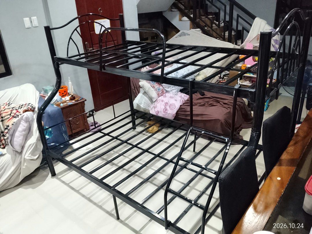 Black Metal Bunk Bed Frame Double Twin Size (Category: Bed Frames & Mattresses) located in Quezon City. Submitted by mjgaudier (Listing ID 1470269849, Image 2). Description: - Type: Black metal bunk bed frame - Size: Double on bottom, Twin on top - Safety: Built-in side ladder and standard upper guardrails - Support: Sturdy metal slats included for both levels - Convenience: Disassembles into pieces for easy transport and moving - Finish: Clean b